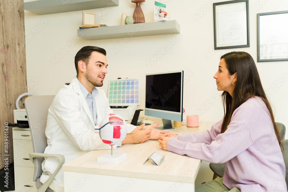 Obraz premium Medical professional explaining vision care to patient using eye model during consultation for medical exam