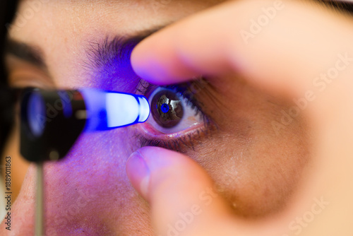 Closeup of ophthalmologist checking patient eye with specialized medical equipment during a detailed vision examination