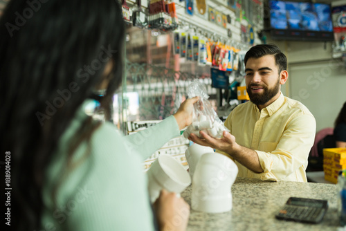 Photography Hardware store clerk assisting a client with plumbing supplies, purchasing pipes
