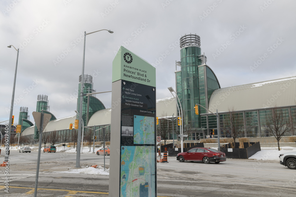 Fototapeta premium location marker at Exhibition Place (Princes' Blvd & Newfoundland Dr) with defocused wide view of the Enercare Centre - National Trade Centre, Toronto