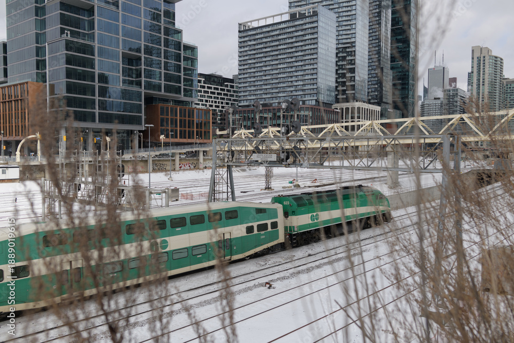 Fototapeta premium Go Train entering the Union Station Rail Corridor viewed from Iceboat Terrace, Toronto