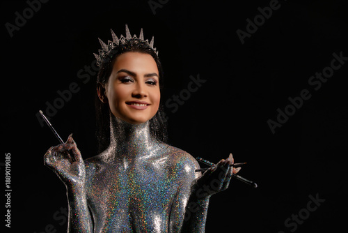 Wallpaper Mural Smiling woman in crown with holographic silver glitter body art holding makeup brushes. Torontodigital.ca