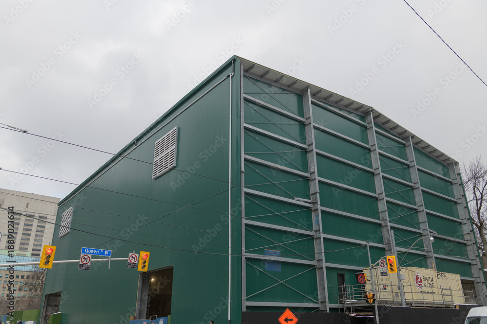 Fototapeta premium Metrolinx construction shed over the future Ontario Line Osgoode Station, at northeast corner of Queen St W and University Av, Toronto