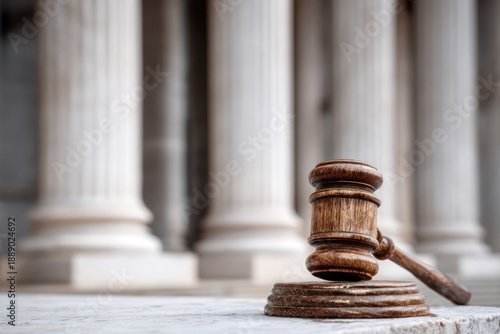 Judge's gavel with classical architecture in background