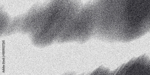 Abstract grayscale texture with grainy effect, resembling clouds or smoke, creating a moody and atmospheric background for design projects