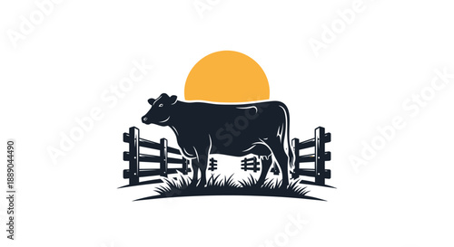 Silhouette of a Holstein cow standing in a field at sunset.
