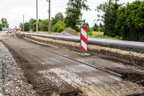 The layer of asphalt road with soil and rock. Un-focus image. Road reconstruction process.