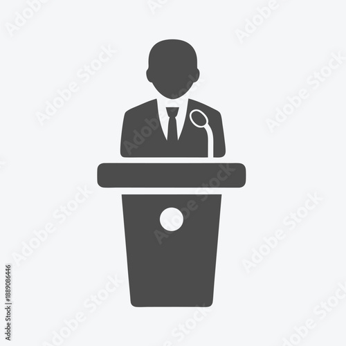 Gray faceless figure at podium gives speech via microphone on white background