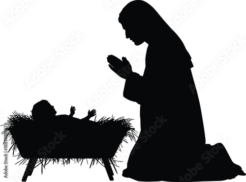 Silhouette of woman kneeling beside manger with baby