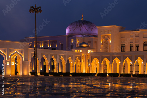 Evening view, illuminated eastern buildings. Architectural elements of buildings, ancient arches and columns. On the streets of the Emirates, in public spaces.