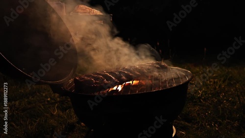 Wallpaper Mural Delicious pork ribs cooking on outdoor grill at night with fire and smoke Torontodigital.ca