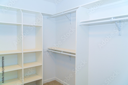 Closet shows open space for shelves hanging rods for clothing other items in house.