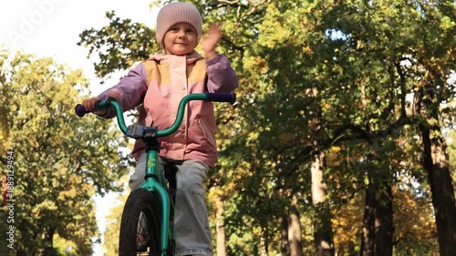 Wallpaper Mural Close up of a small girl smiling while riding a bike on a beautiful sunny day Torontodigital.ca