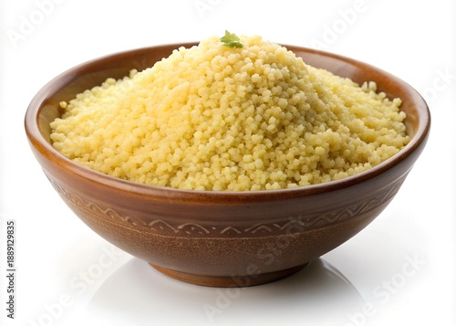 A brown ceramic bowl filled with fluffy yellow cooked couscous and a green garnish, presented on a reflective white background