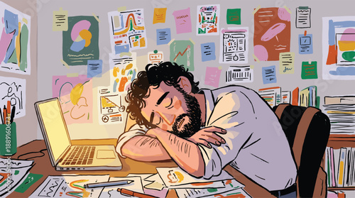 A tired bearded man sleeping on his cluttered desk surrounded by creative work and glowing laptop.