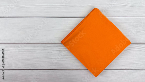 Konstfotografi Stack of orange napkins on white wooden background with copy space