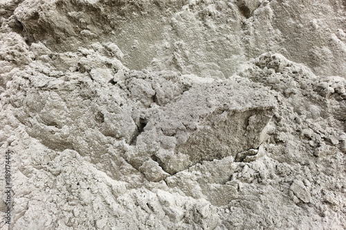 Texture of wet gray sand, background, texture. Close-up view of rough grey sand or dry cement texture with uneven, granular surface. Perfect for use in construction themes, industrial backgrounds. 