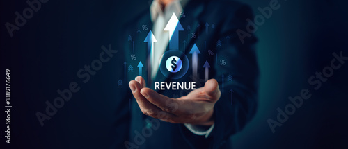 Businessman holding virtual revenue growth hologram with dollar sign and upward arrows. Financial profit increase concept for corporate sales success, economy investment and money income market.