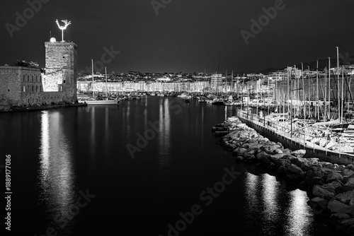 Marseille, Provence, France: Entrance into the Old Port of Marseille by the Fort of Saint John illuminated at twilight in black and white