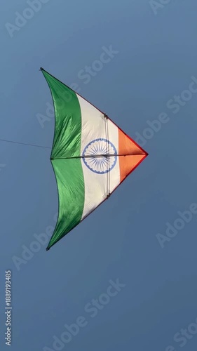 Indian flag kite flying in blue sky during kite festival celebration