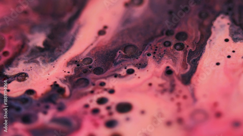 Ink stains. Oil droplet. Defocused pink purple color sparkling water wet mix acrylic liquid leaking on abstract art chemical background.