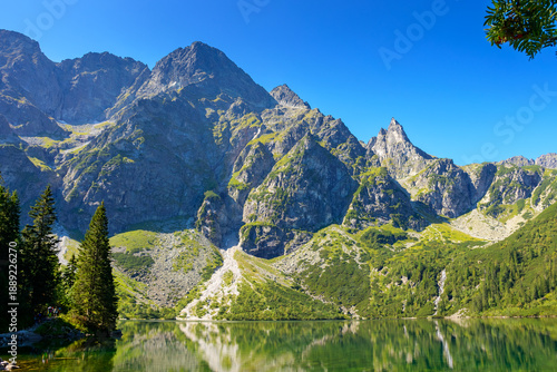 landscape with lake in mountains. scenic nature of poland with rocky peaks in summer. high tatras are wonderful place for travel in eastern europe