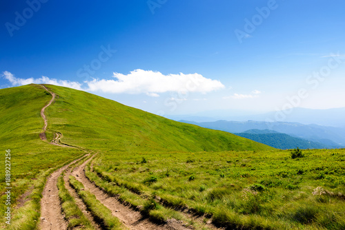 mountain trail to the top of the summit. summer travel landscape under deep blue sky with fluffy clouds. sunny weather. borzhava ridge of transcarpathia, ukraine