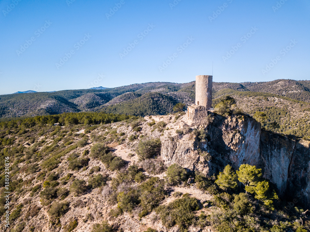 Fototapeta premium The medieval castle El Castellot with a tower in the mountains of Spain, drone photo
