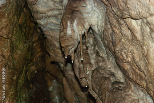 Stalactite and Flowstone Formations Inside Limestone Cave