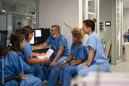 Medical team reviewing data together in a modern hospital setting