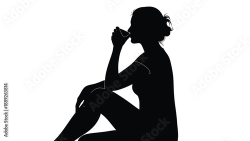 Silhouette of a woman sitting down and drinking from a small glass or cup in profile view