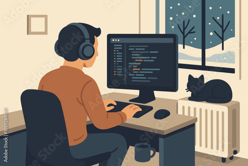 Person works on computer while a cat sleeps on a radiator next to a window with snow outside in a home office at night