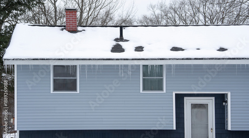 winter house with icicle and snow on the roof © nd700