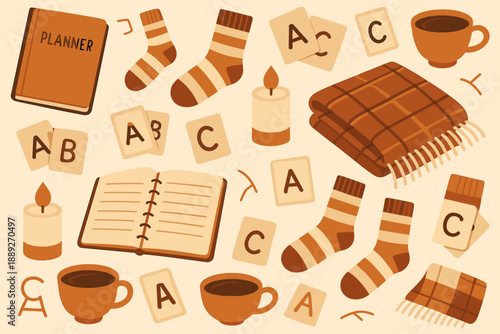 Cozy items for indoor activities during autumn season with planner, books, blankets, and warm drinks