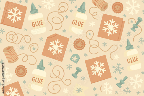 Craft supplies are on a table with glue bottles, snowflakes, and brown paper in a creative workspace