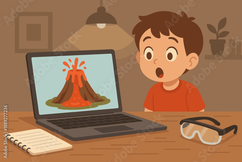 Young boy watches volcano eruption video on laptop at home while taking notes