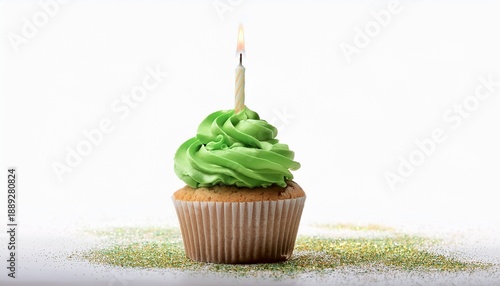 Festive Cupcake With Green Frosting And A Lit Birthday Candle On White