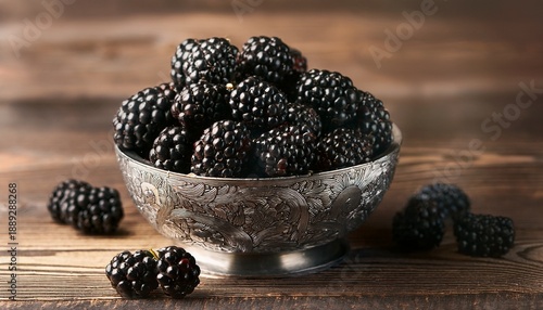 Close Up Of Blackberries In A Detailed Silver Bowl On A Wood Surface
