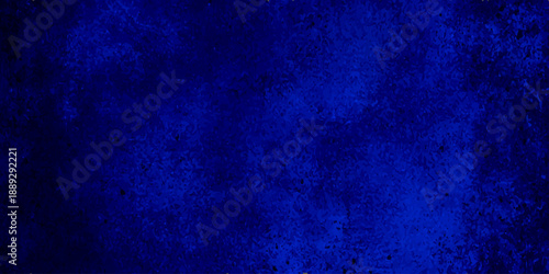 A dark and aged blue grunge wall background with a vintage textured surface featuring rough paint patterns and purple light accents on a dirty canvas material