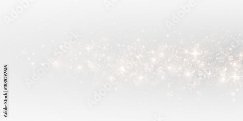 Festive sparks and shimmering stardust in a glowing abstract background. Gold glitter particles and confetti spray with luminous holiday sparkle.