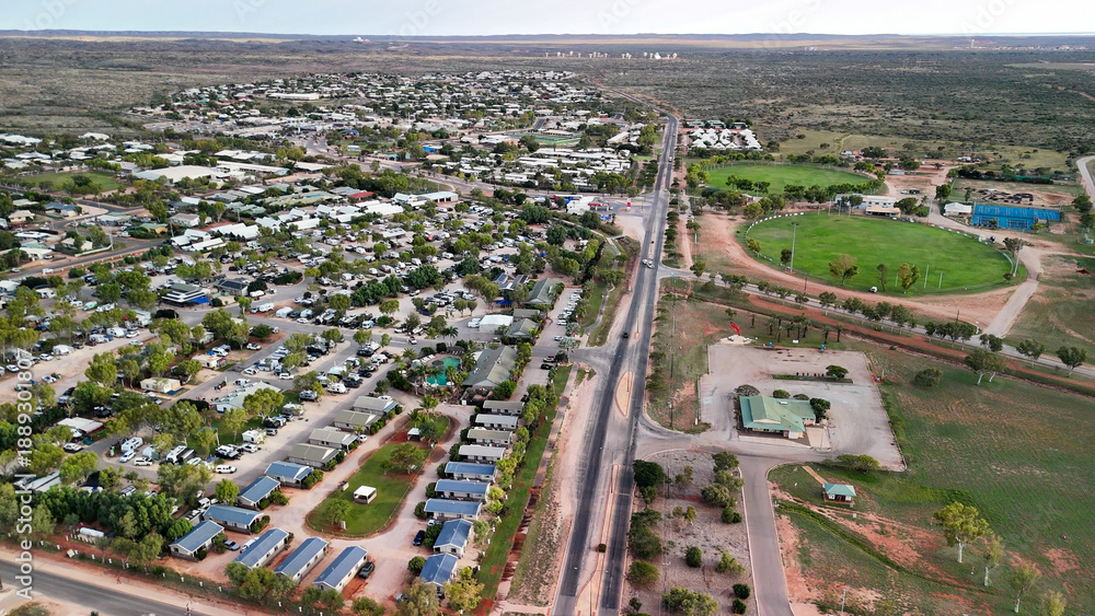 Fototapeta premium Birds eye perspective showcasing Exmouth neighborhood houses coastal township harbor turquoise ocean backdrop Australia