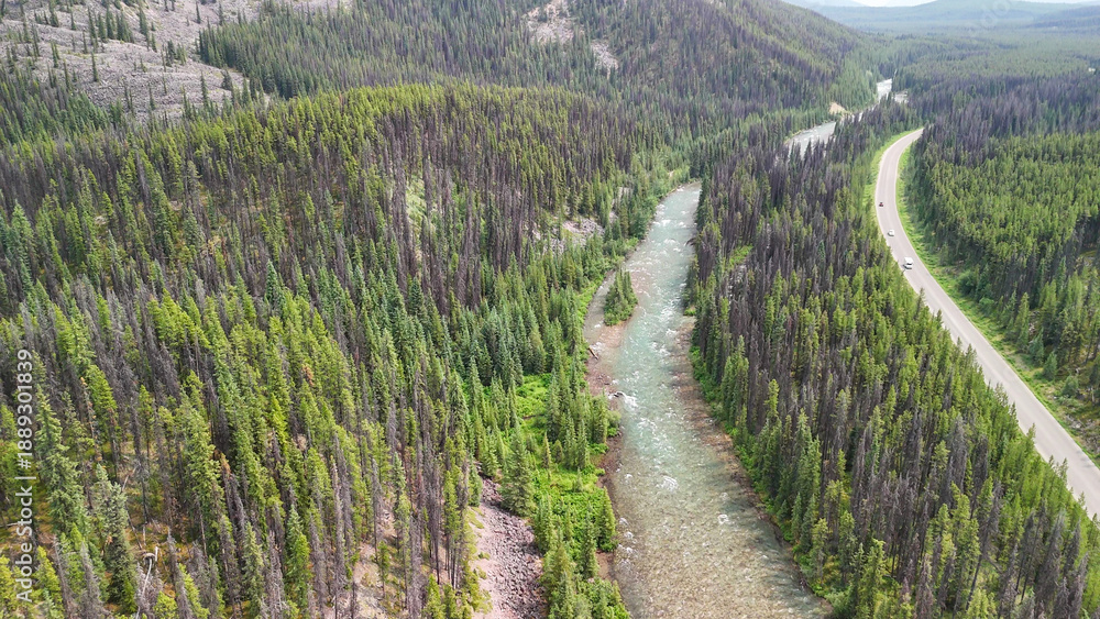 Fototapeta premium Jasper aerial cityscape with Athabasca River surrounded by mountains and green summer scenery