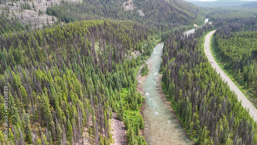 Jasper aerial cityscape with Athabasca River surrounded by mountains and green summer scenery