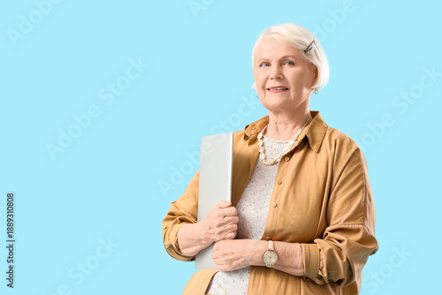 Senior woman with laptop on...