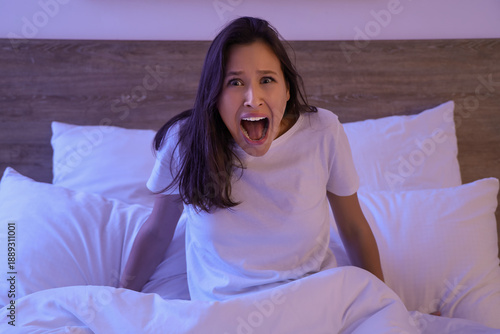 Scared young woman screamin...