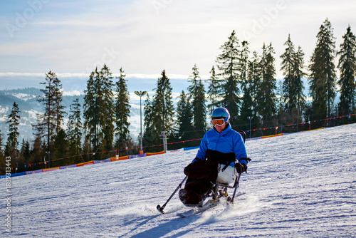 A man in a blue jacket confidently skis