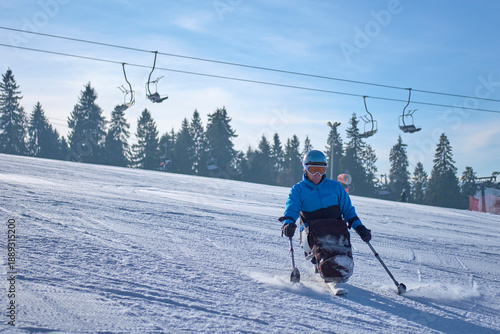 Mountain vacation - a man in a blue jacket skiing down a mountain