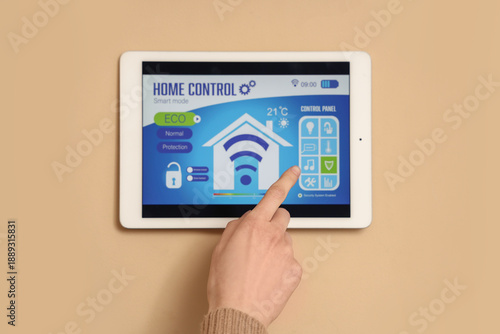 Female hand using smart hom...