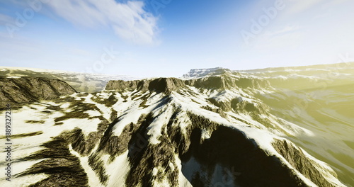 Obraz na plátně Snowy mountain ridge under bright sky, wide panoramic vista of jagged peaks, gla