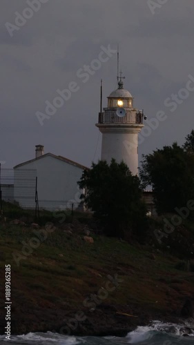 The most important warning for sailors is the lighthouse. The red historical lighthouse in Akyarlar, Bodrum, built in 1931, also showing the directions. Vertical video for social media.